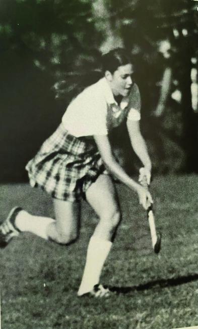 Carol Quillen going to hit a ball in field hockey 