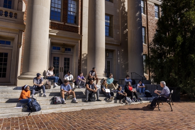 Students gather for an outdoor class on the steps of chambers