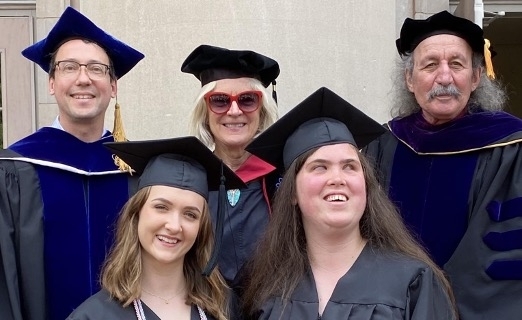 group of students and faculty together in graduation robes