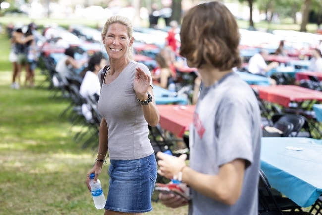 Parent waving goodbye to student