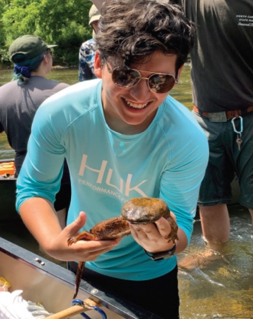 Raul Galvan ’21 holding frogs 