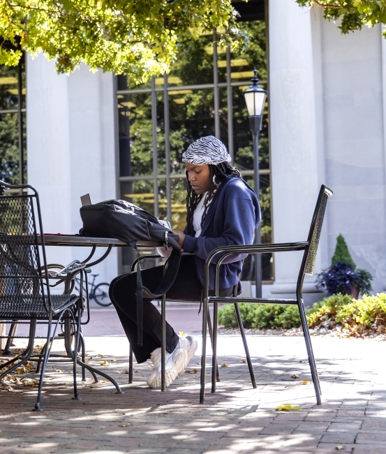 Student on laptop sitting outside