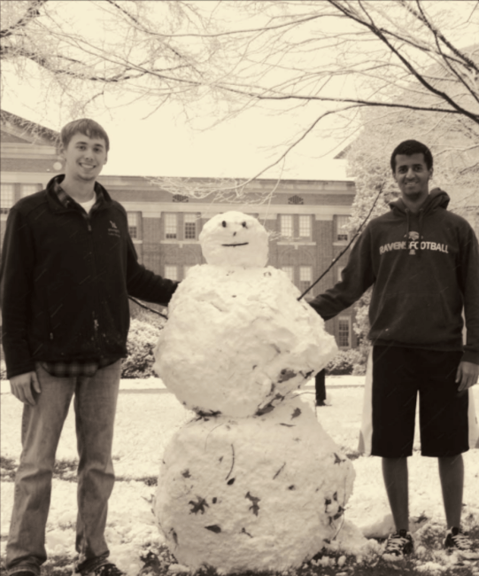 Students with snowman on campus