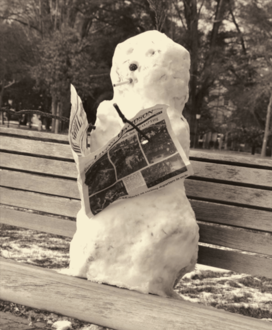 Snowman reading the paper on campus bench