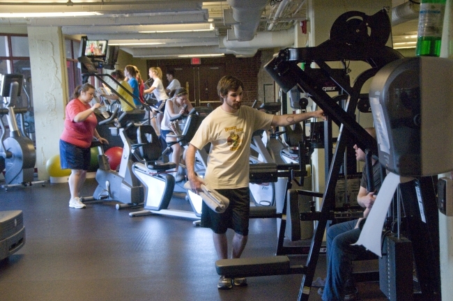 students and staff working out in gym