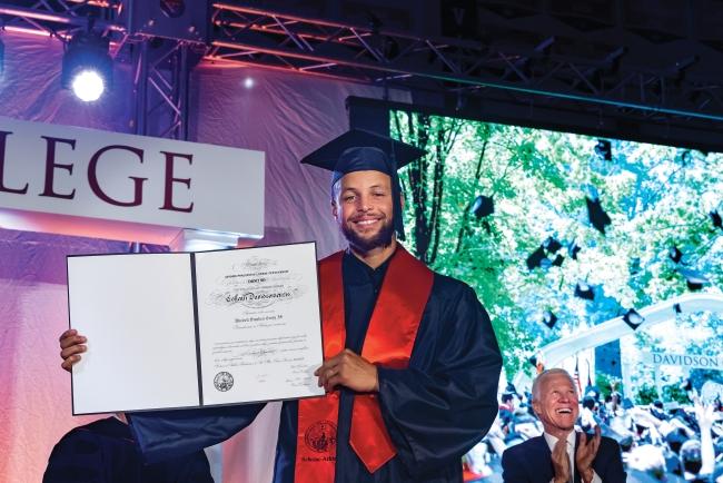 Stephen Curry showing his diploma
