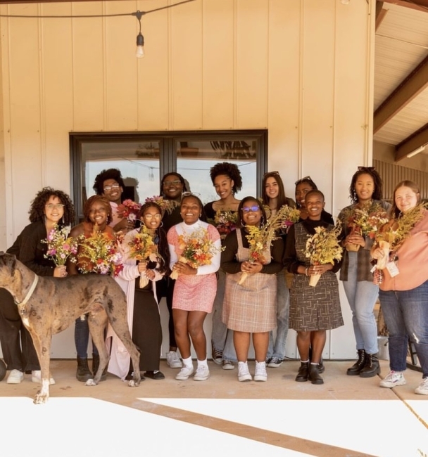 women holding bouquets of flowers