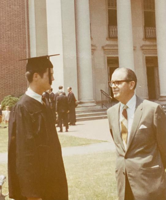 male in graduation robes with older man in suit