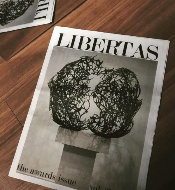 Magazines with art and "LIBERTAS" on cover