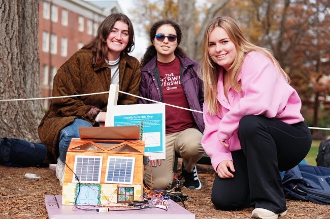 three students with solar powered tiny town