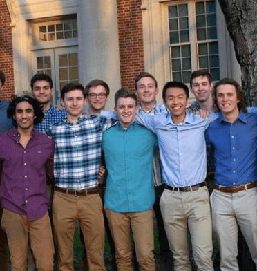 male students smiling at camera