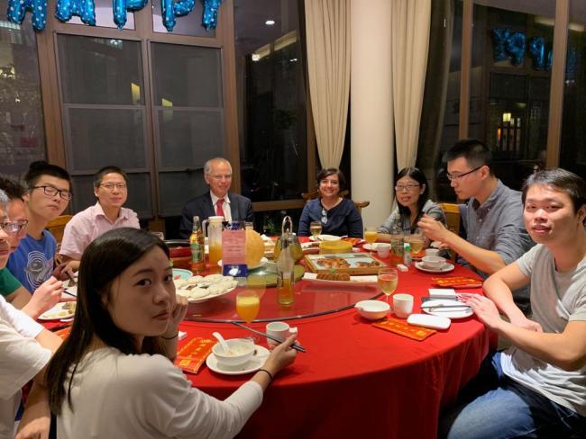 Professor at dining table with Chinese students