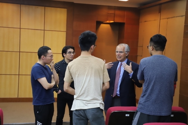 Professor speaking to students in small group