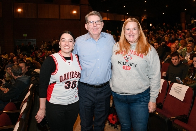 President Doug Hicks standing with two women in Davidson gear at Sundance Film Festival