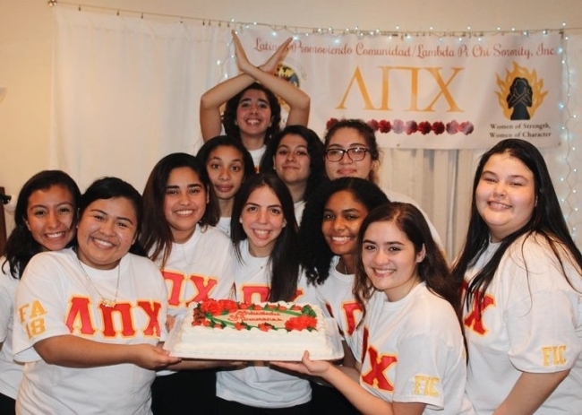 Latinx Sorority Women holding a cake