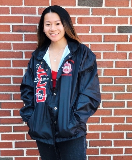 Woman in Delta Sorority leather jacket