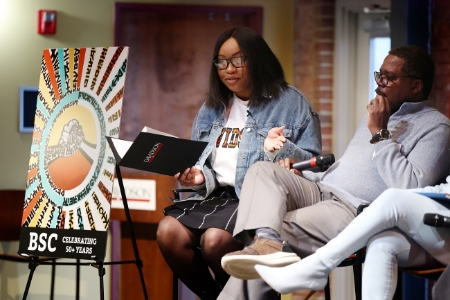 black students and alumni on stage speaking as part of a panel