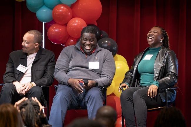 BSC panelists smiling and laughing, balloons in background