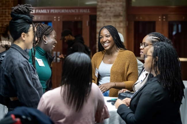 Group of women smiling and talking to each other