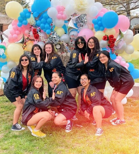 Latinx Sorority in front of balloon arch