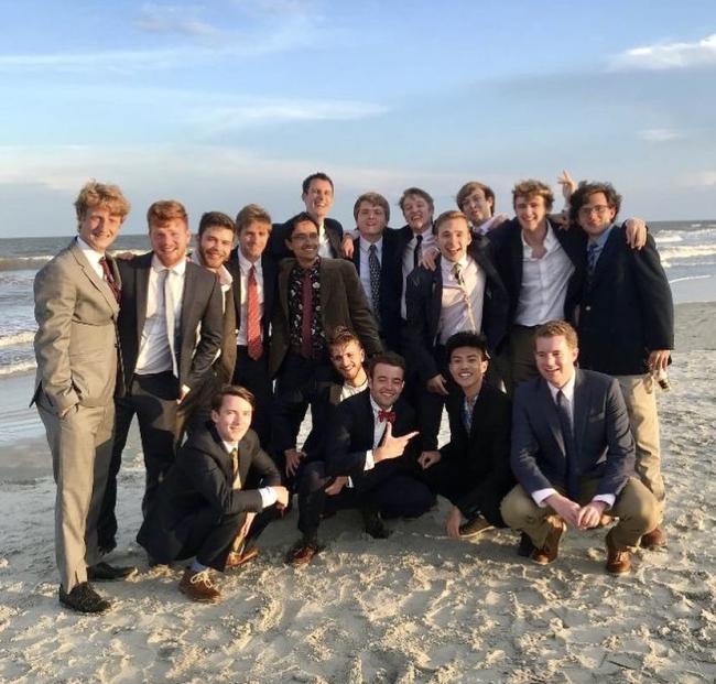 Group of fraternity men on beach