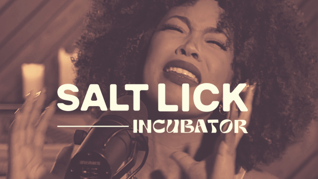 Salt Lick Incubator logo over a woman singing