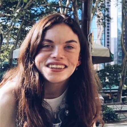 A woman with brown hair smiles 