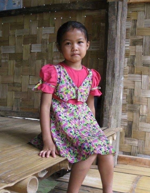 A young child wearing a floral dress