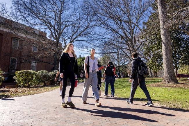 Two students walk together on campus