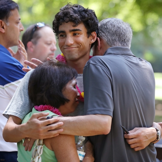 Family embraces at outdoor picnic