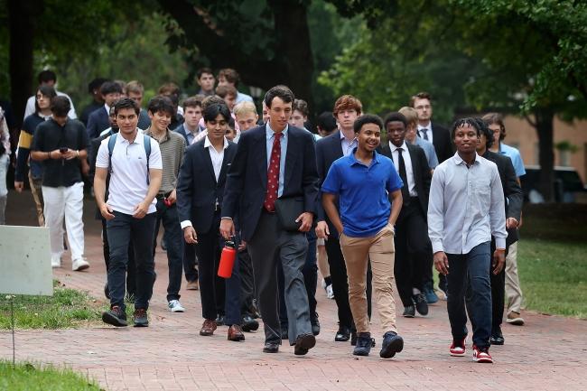 Students walk in dressy attire across campus