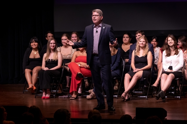 President Hicks speaks on stage as Honor Council sits behind him