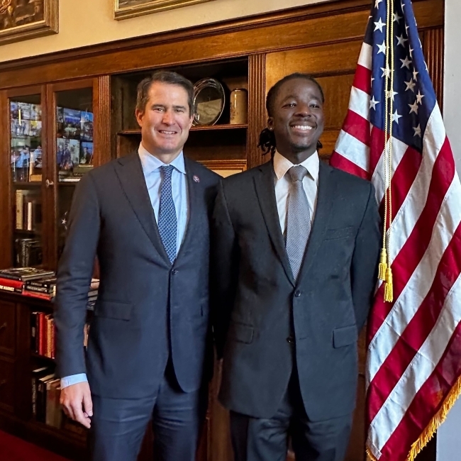 Nathanael Bagonza ’24 and male senator wearing blue suit