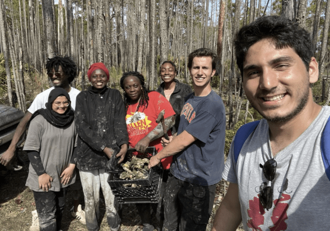 a group of students on an alternative break smiling and outside