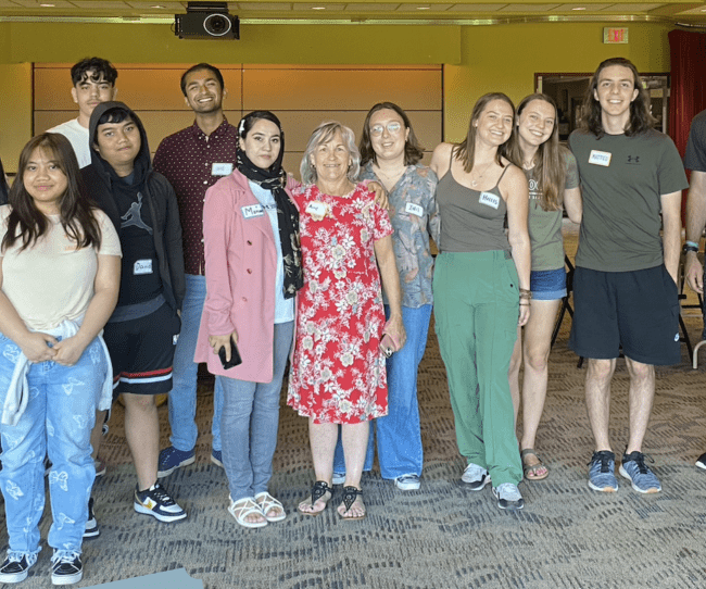 a group of students involved with the refugee support organization standing and smiling