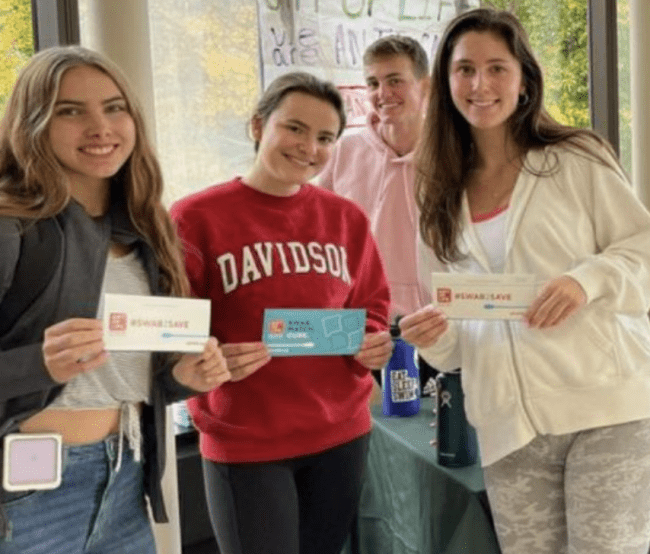 a group of students holding certificates and smiling