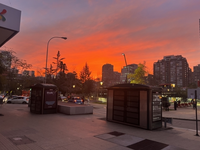 a pink and orange sunrise over a city skyline