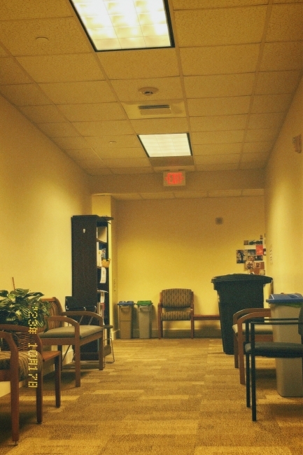 a waiting area with chairs and overhead lights