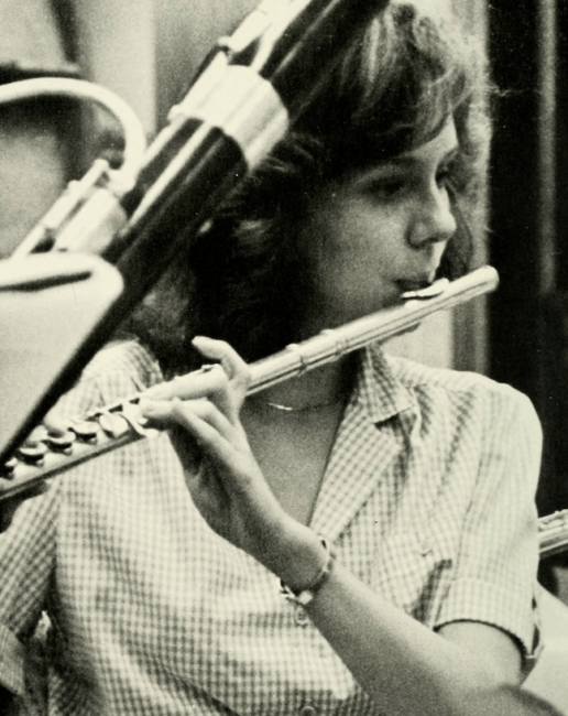 a young woman playing the flute