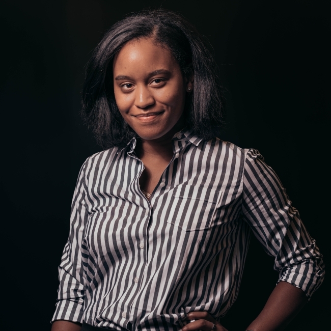 a young Black woman wearing a striped shirt