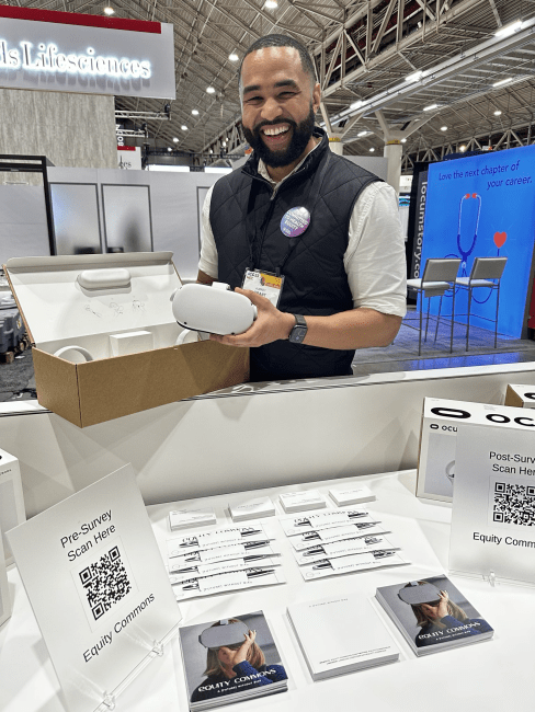 a young man holds a VR set and smiles