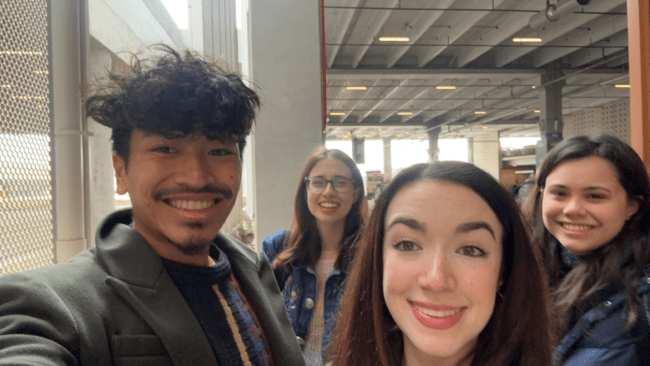 a group of young men and women take a selfie