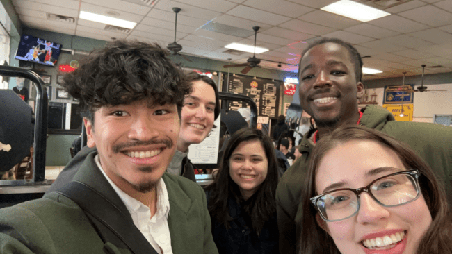 a group of young men and women take a selfie