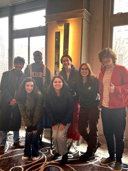 a group of young men and women standing and smiling