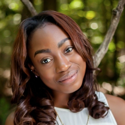 a young Black woman smiles