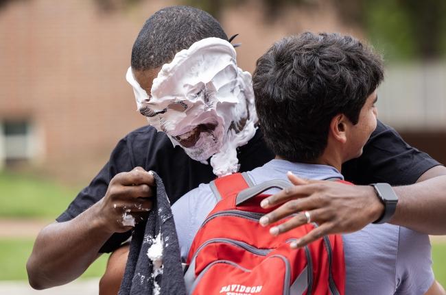 All In For Davidson Chris Clunie hugging student after being pie'ed