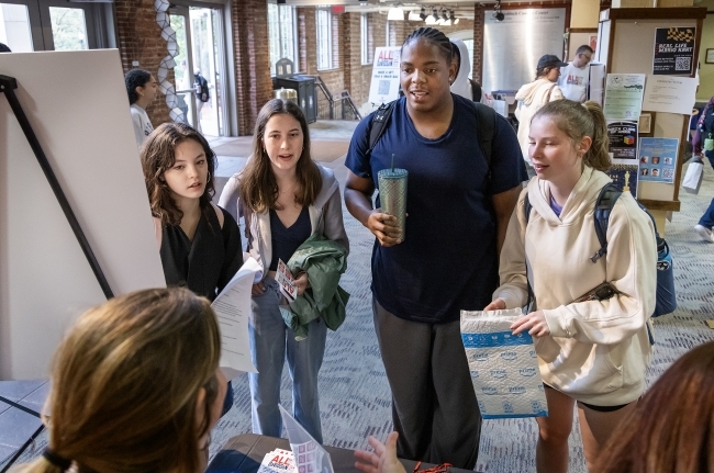 a group of students standing around and smiling