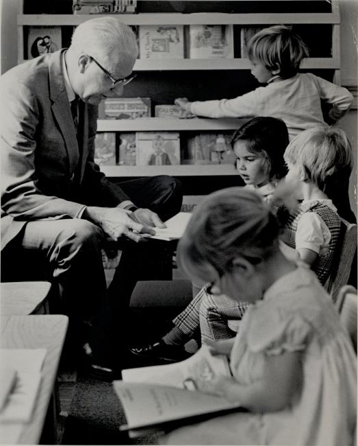Prof. George Abernethy reading to children