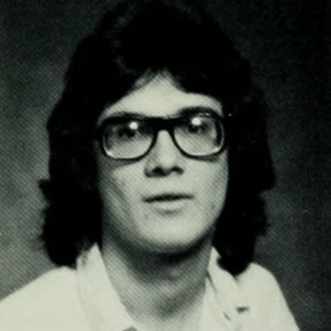 a young white man wearing glasses in a black and white photo