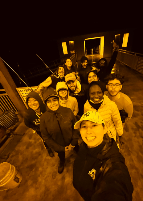 a group of young people take a selfie together at night